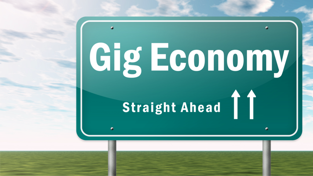 road sign that says "Gig Economy, Straight Ahead" with 2 arrows facing up